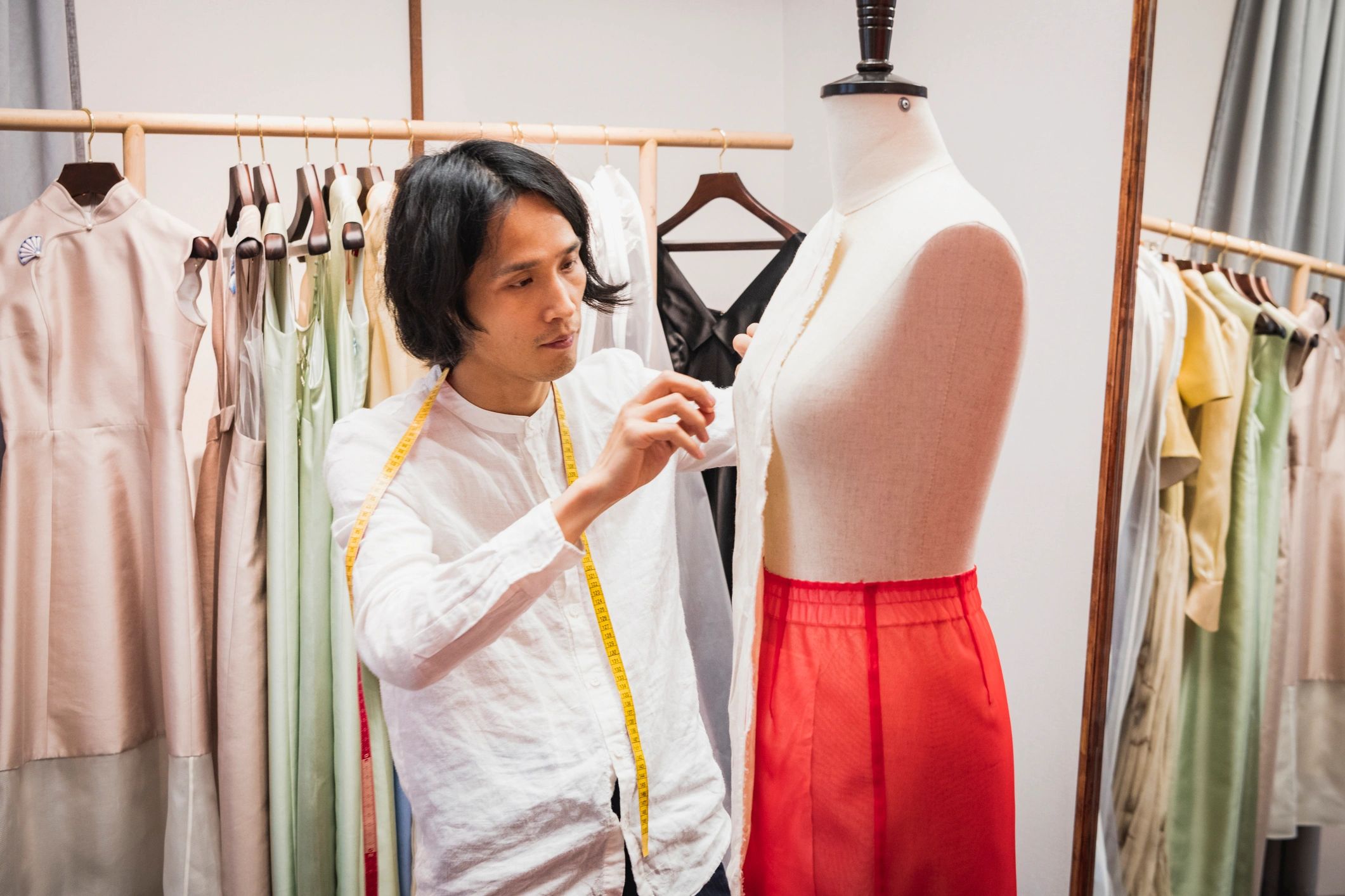 Person measuring a garment with a tape measure