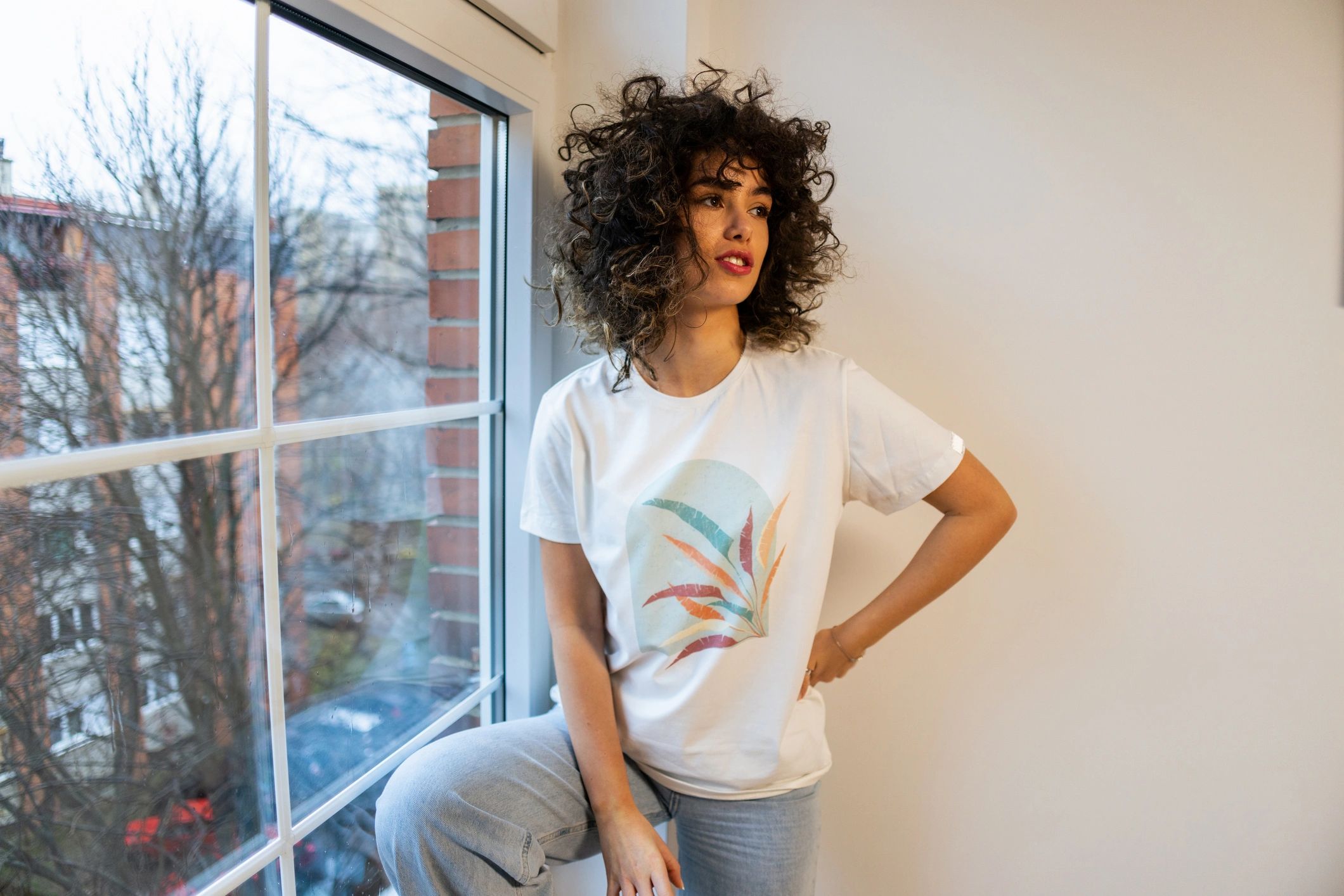 Portrait of a young woman in a white T-shirt.