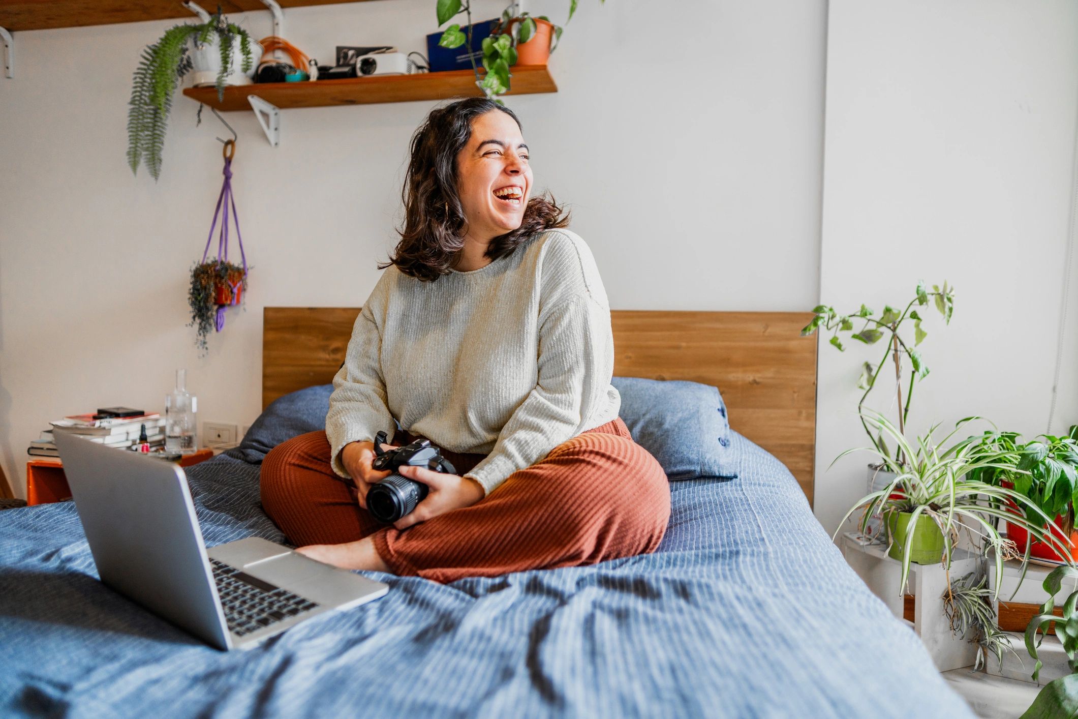 Photographer working on a laptop editing photos at home.